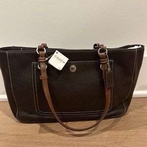 Brand new with tags. Classic Coach Brown leather tote with a purple lining.